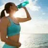 Healthy woman drinking electrolytes.
